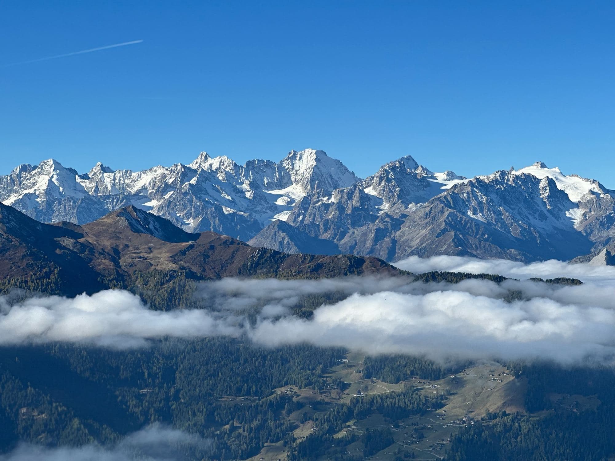 Snow-capped peaks above a sea of clouds